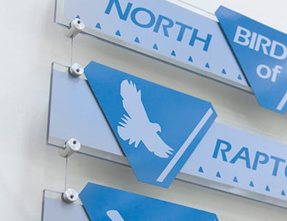 Suspended display panels clamped neatly along modular tensioned wire cables