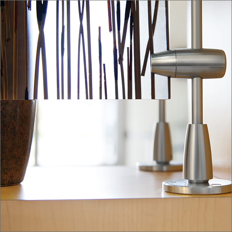 Line drawing of a metal rod mounted vertically to a floor using a round base flange.